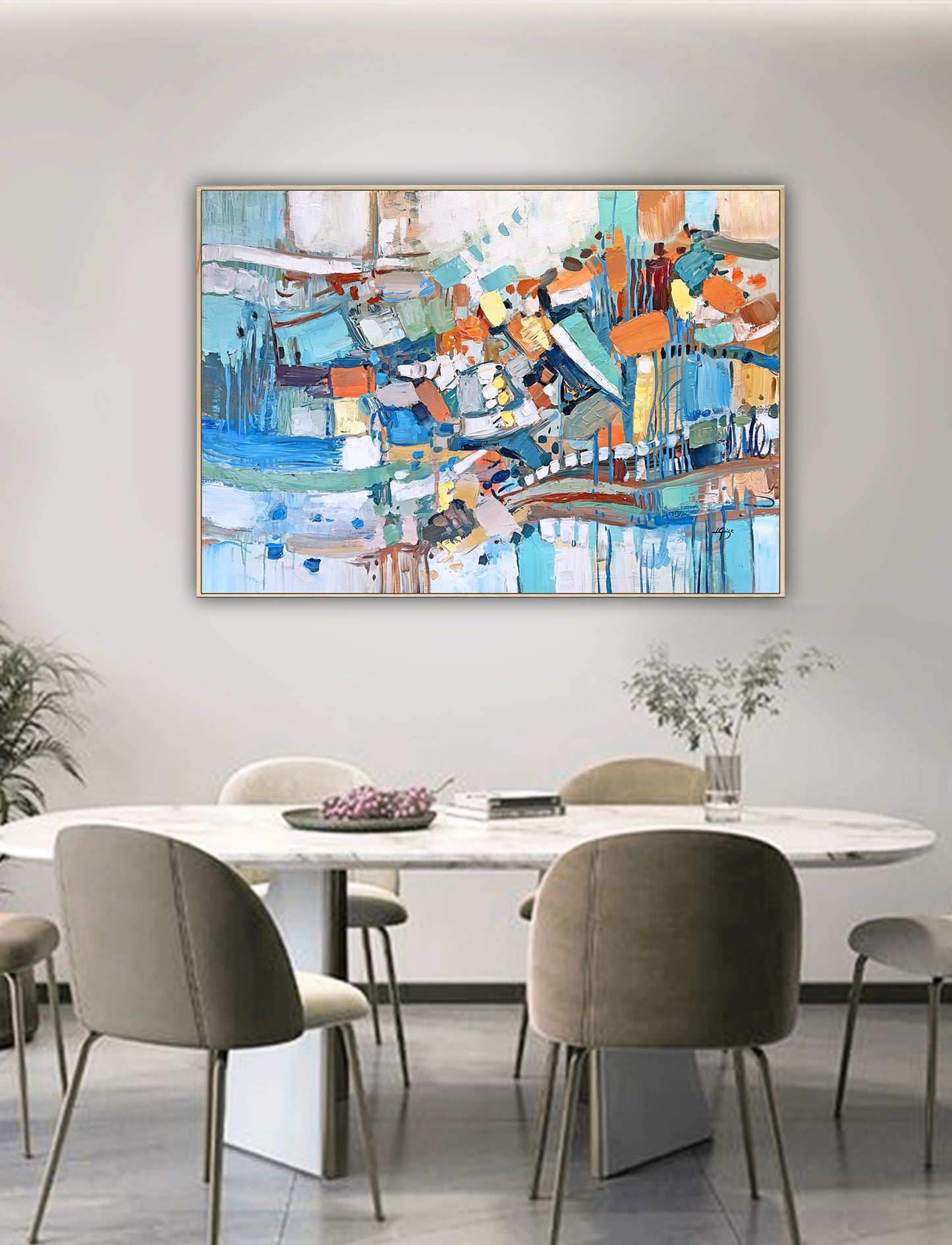 a painting on a wall above a dining room table