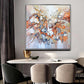 a painting hanging on a wall above a dining room table