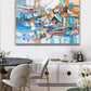 a painting hanging on a wall above a dining room table