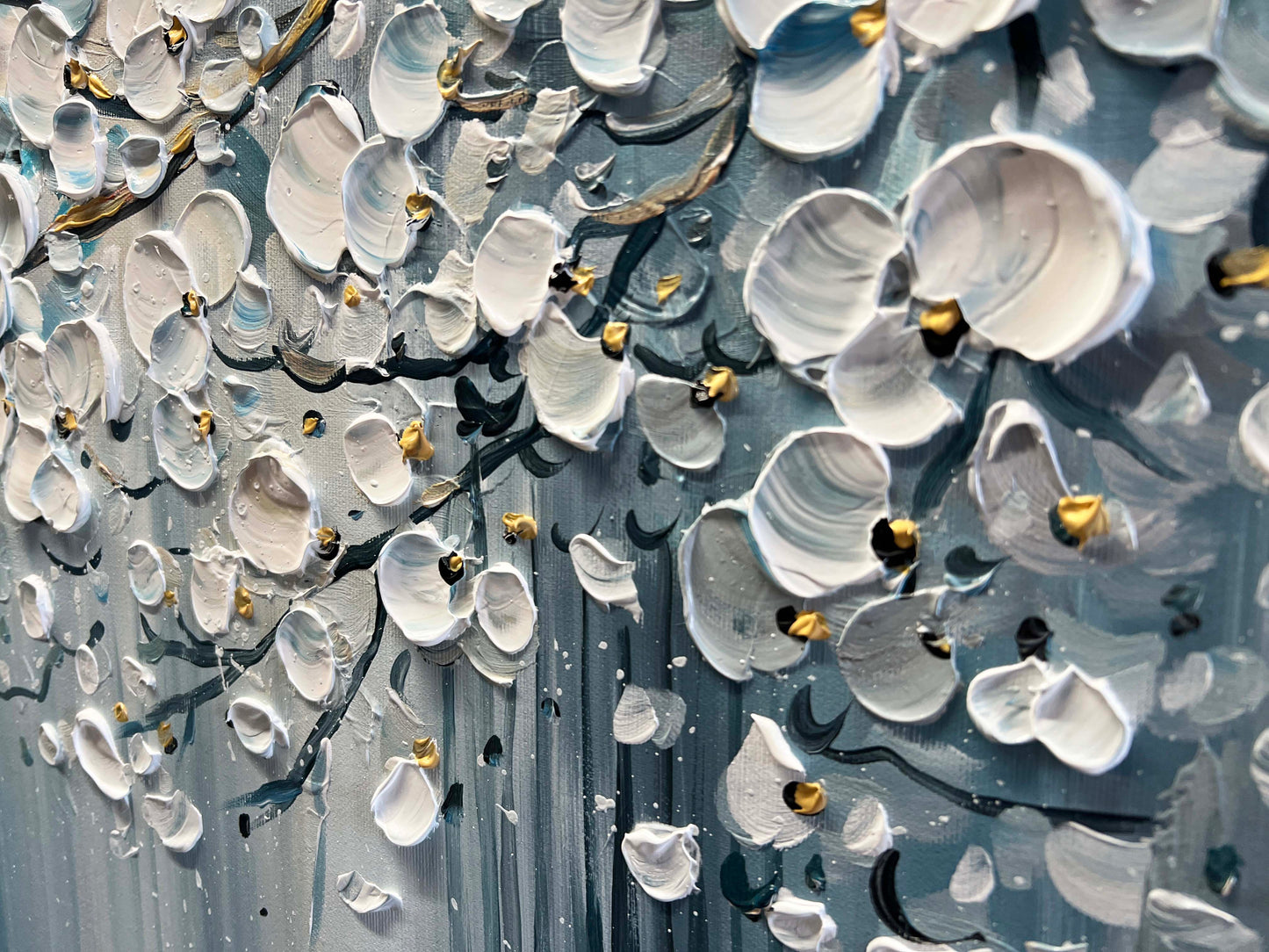 a painting of white and gold flowers on a gray background