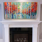 a fireplace with a painting on the mantle