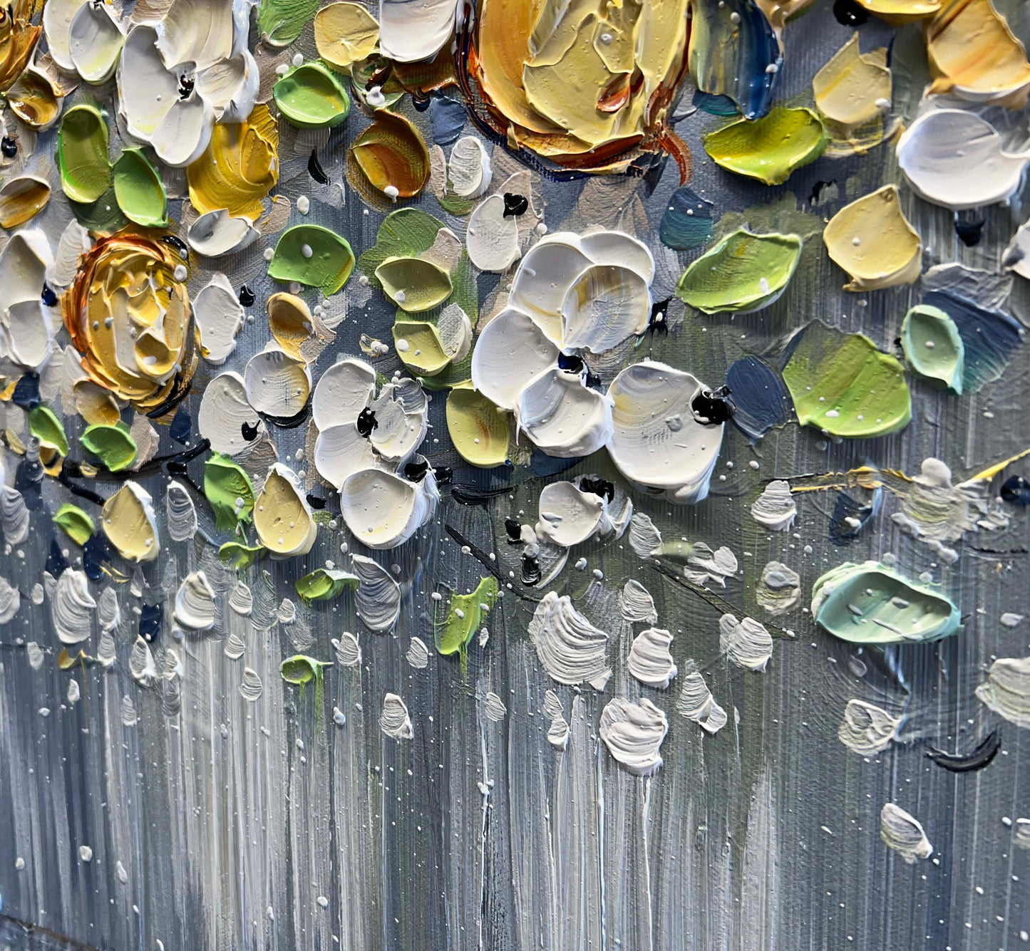 a close up of a painting of flowers on a wall