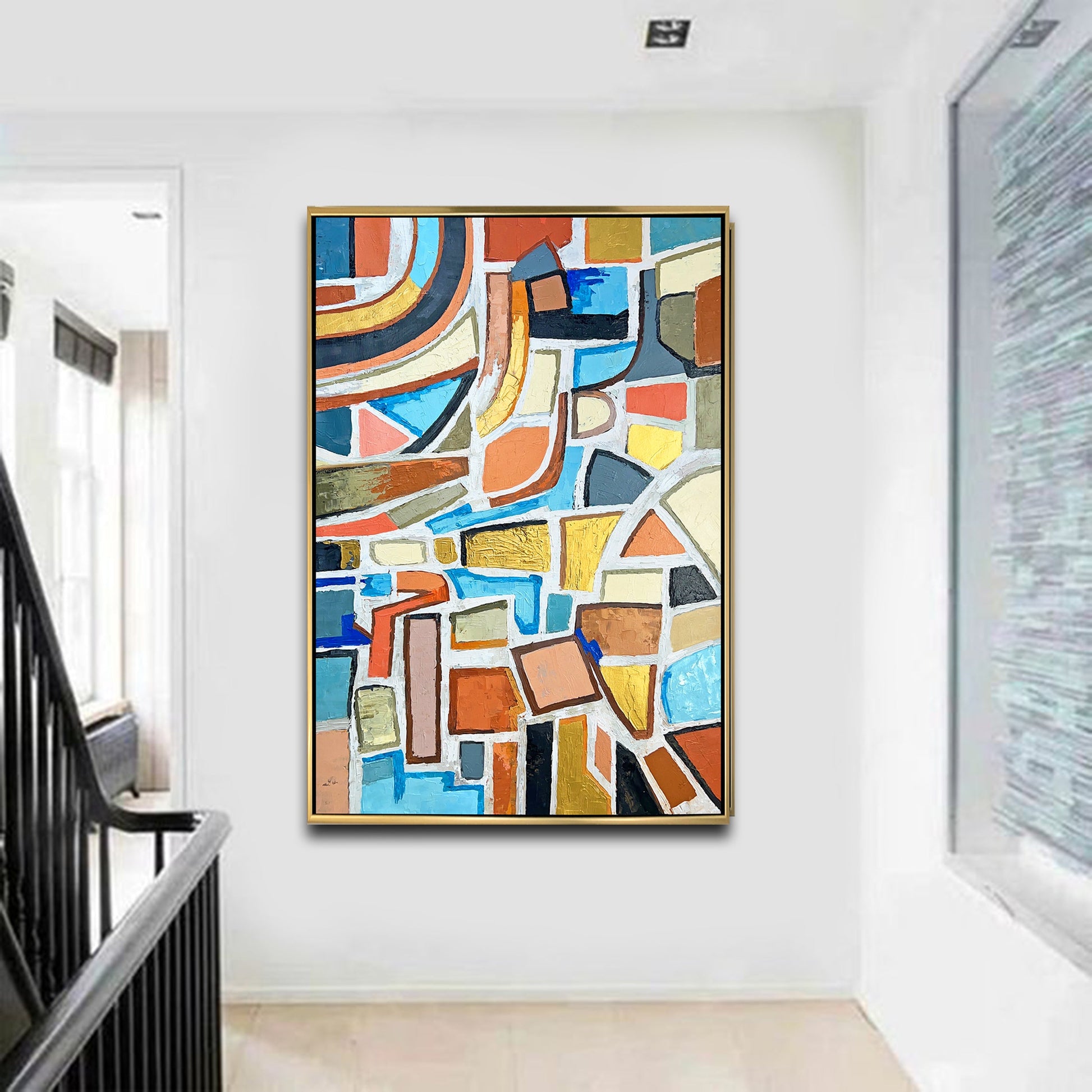 a painting hanging on a wall next to a stair case