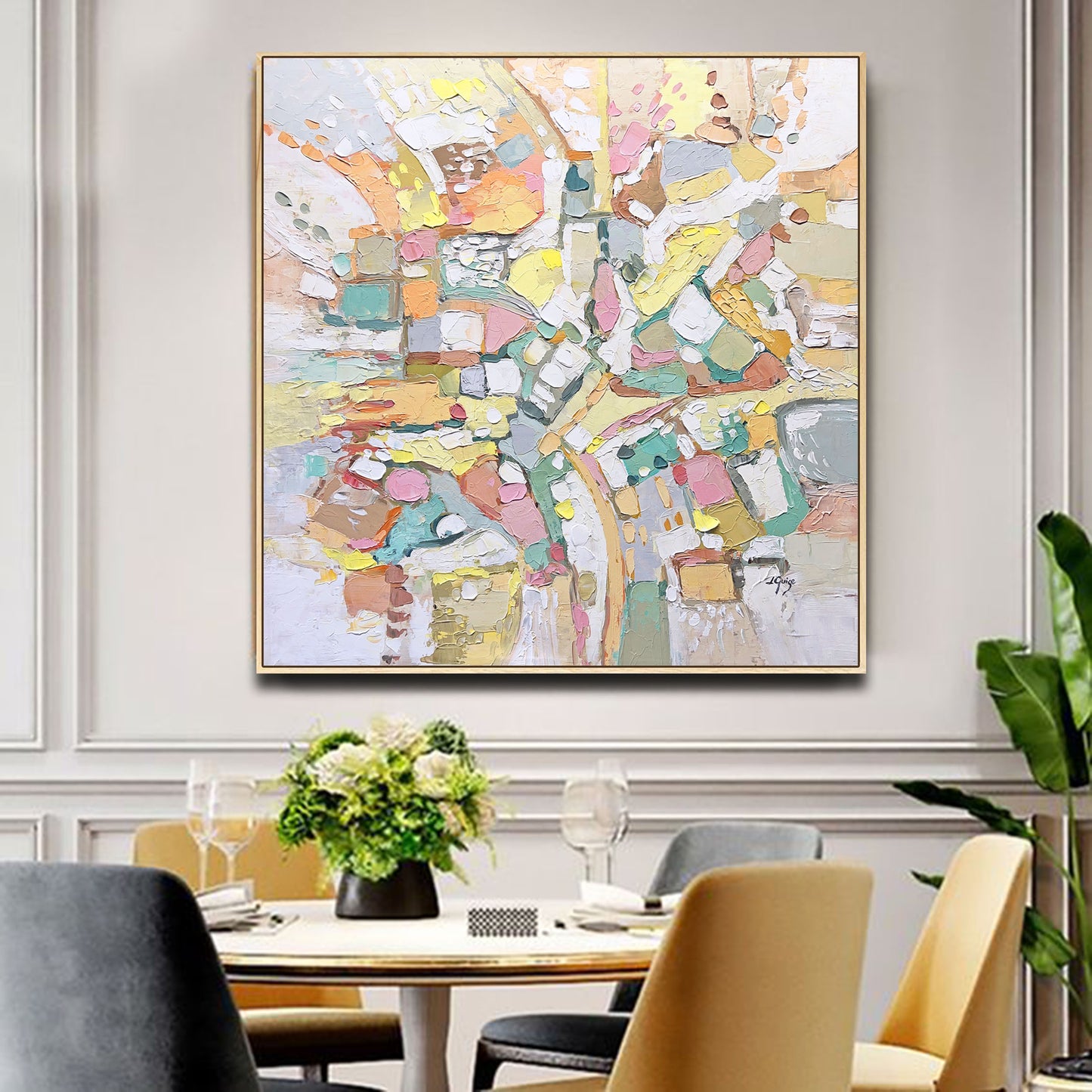 a painting hanging on a wall above a dining room table