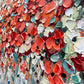 a painting of red and white flowers on a wall