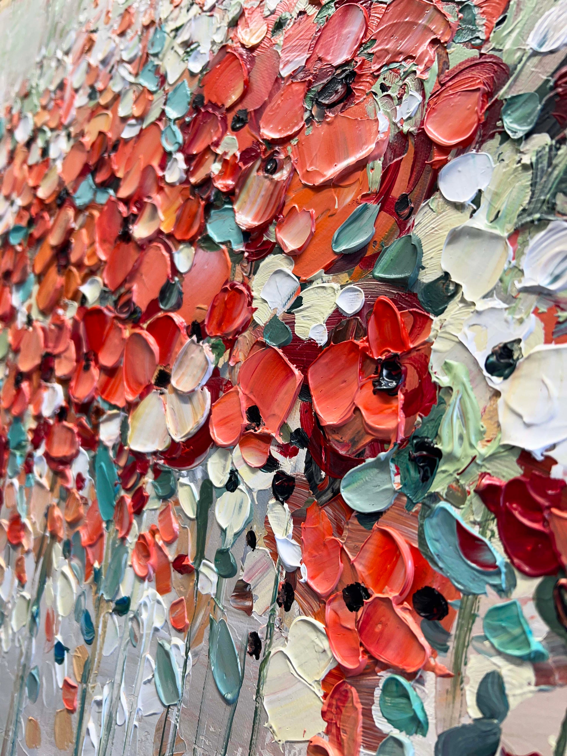 a painting of red and white flowers on a wall