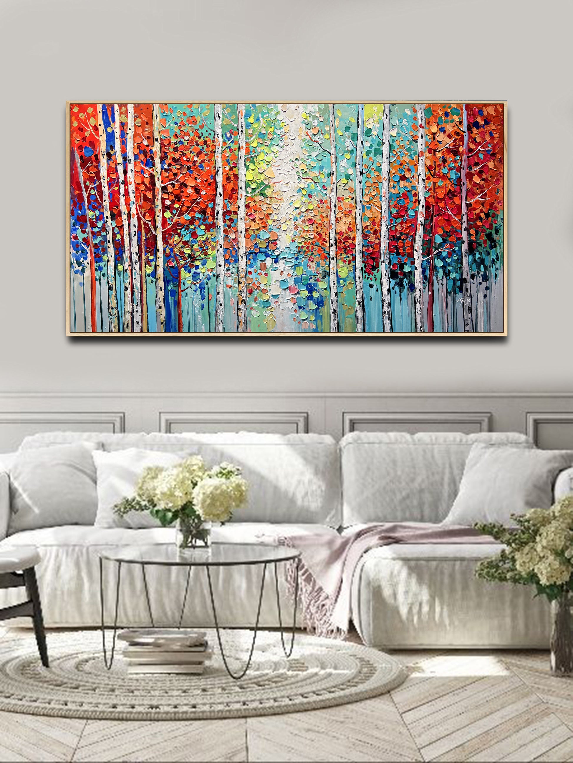 a living room with a large painting on the wall