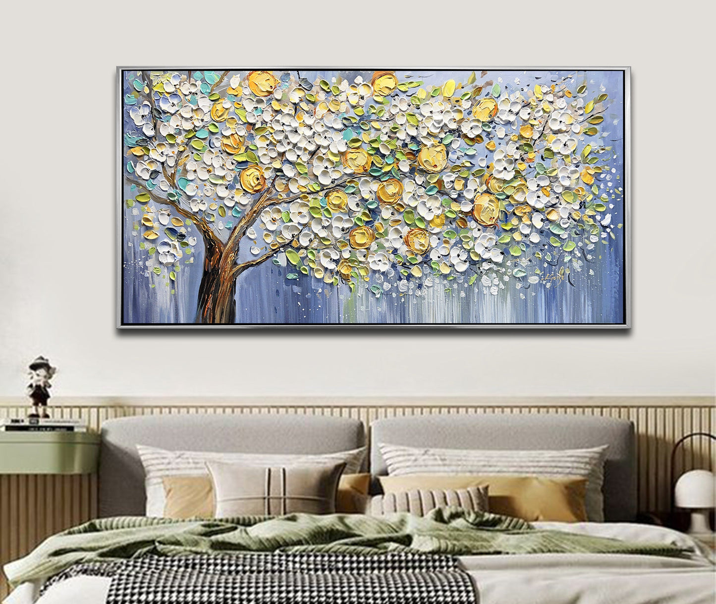 a painting of a tree on a wall above a bed