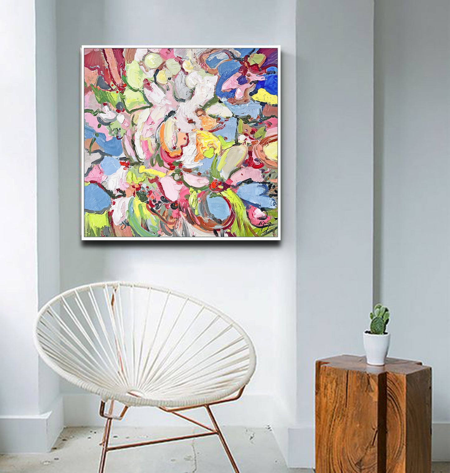 a white chair in a room with a painting on the wall