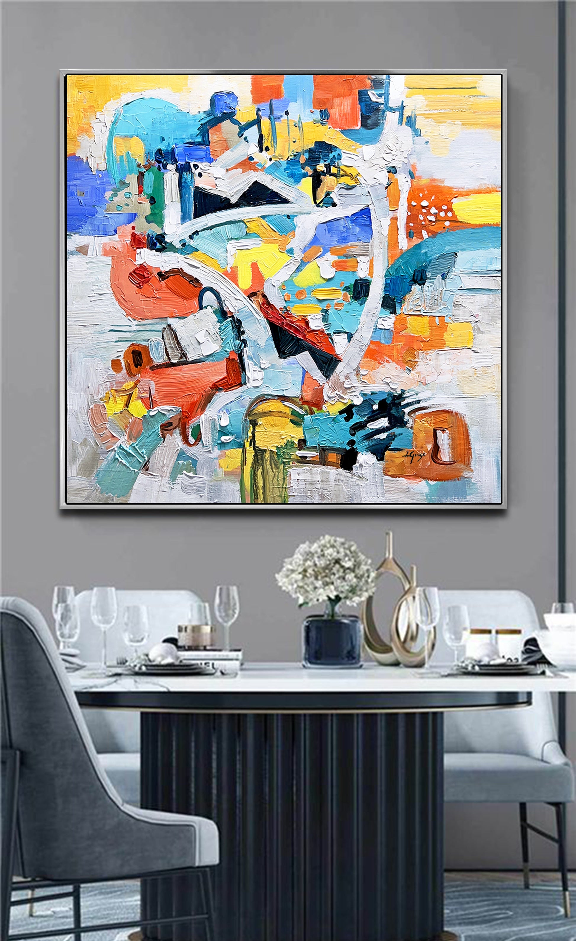 a painting hanging on a wall above a dining room table