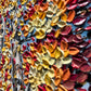 a wall with a bunch of different colored flowers on it