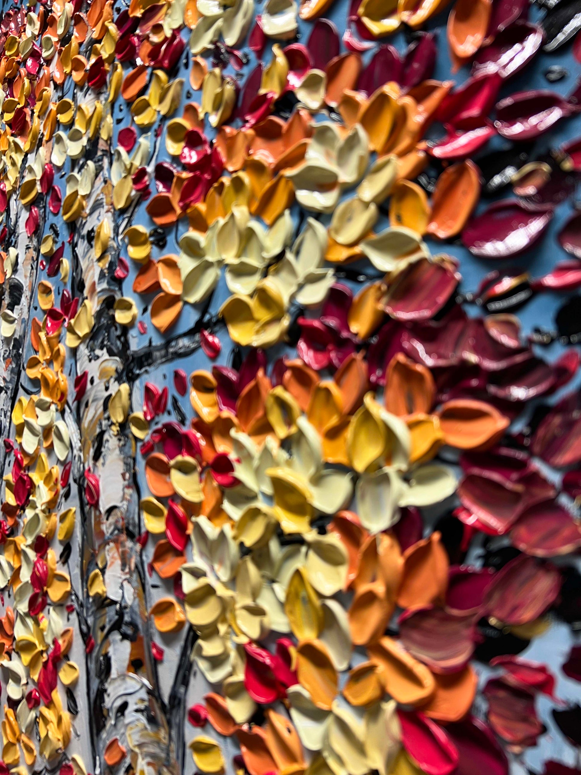 a wall with a bunch of different colored flowers on it