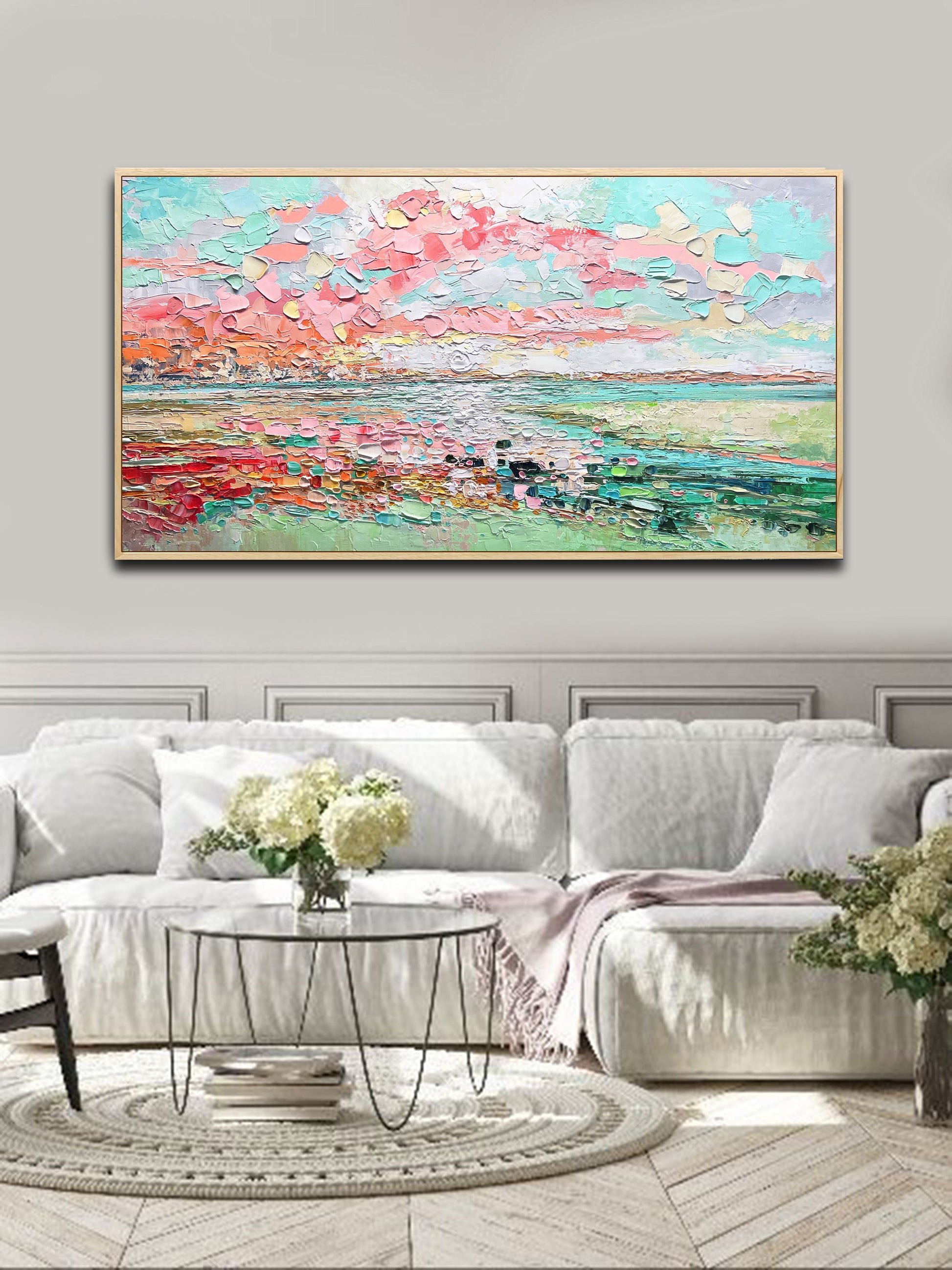 a living room with a large painting on the wall