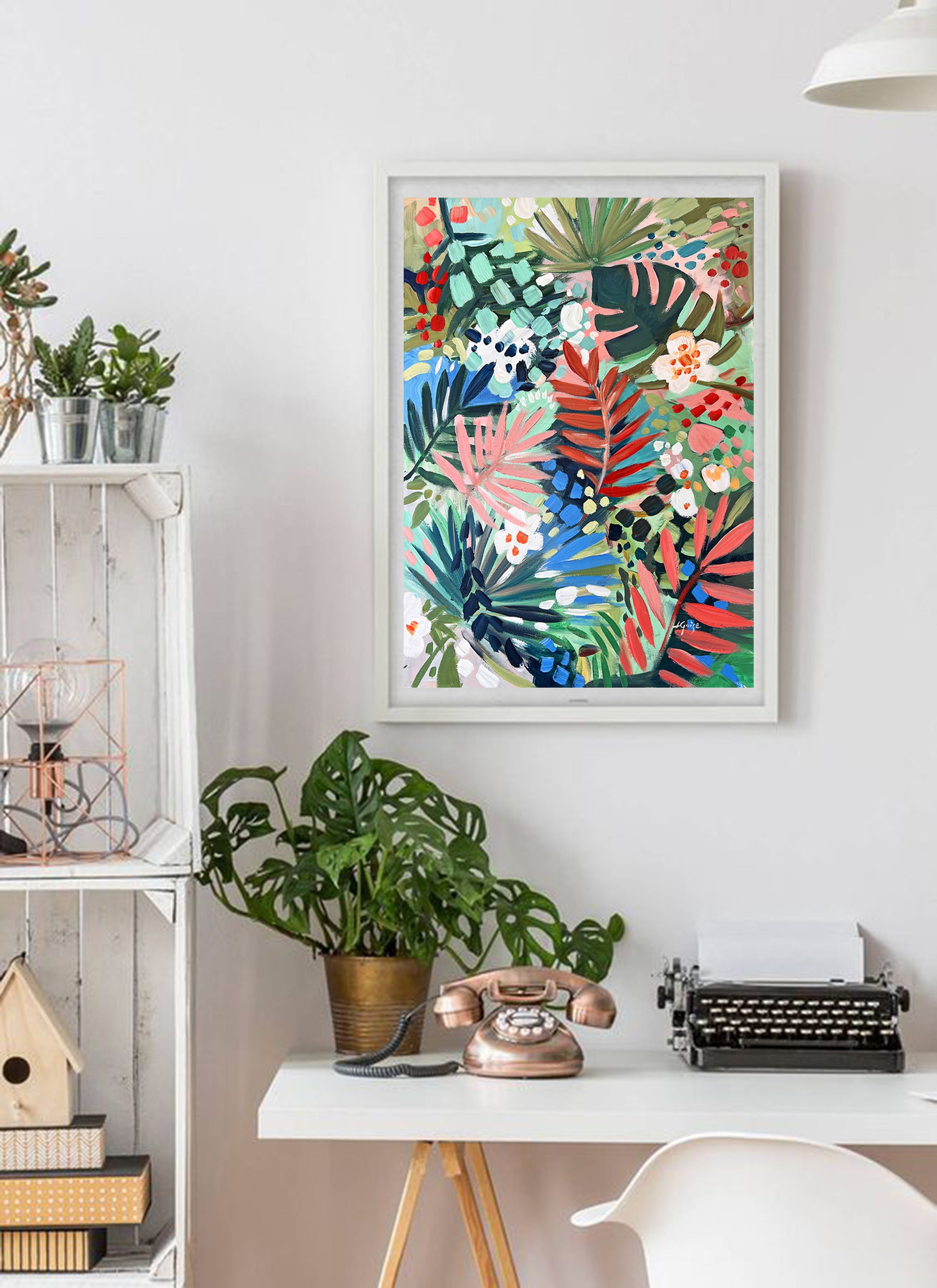 a white desk with a white chair and a painting on the wall