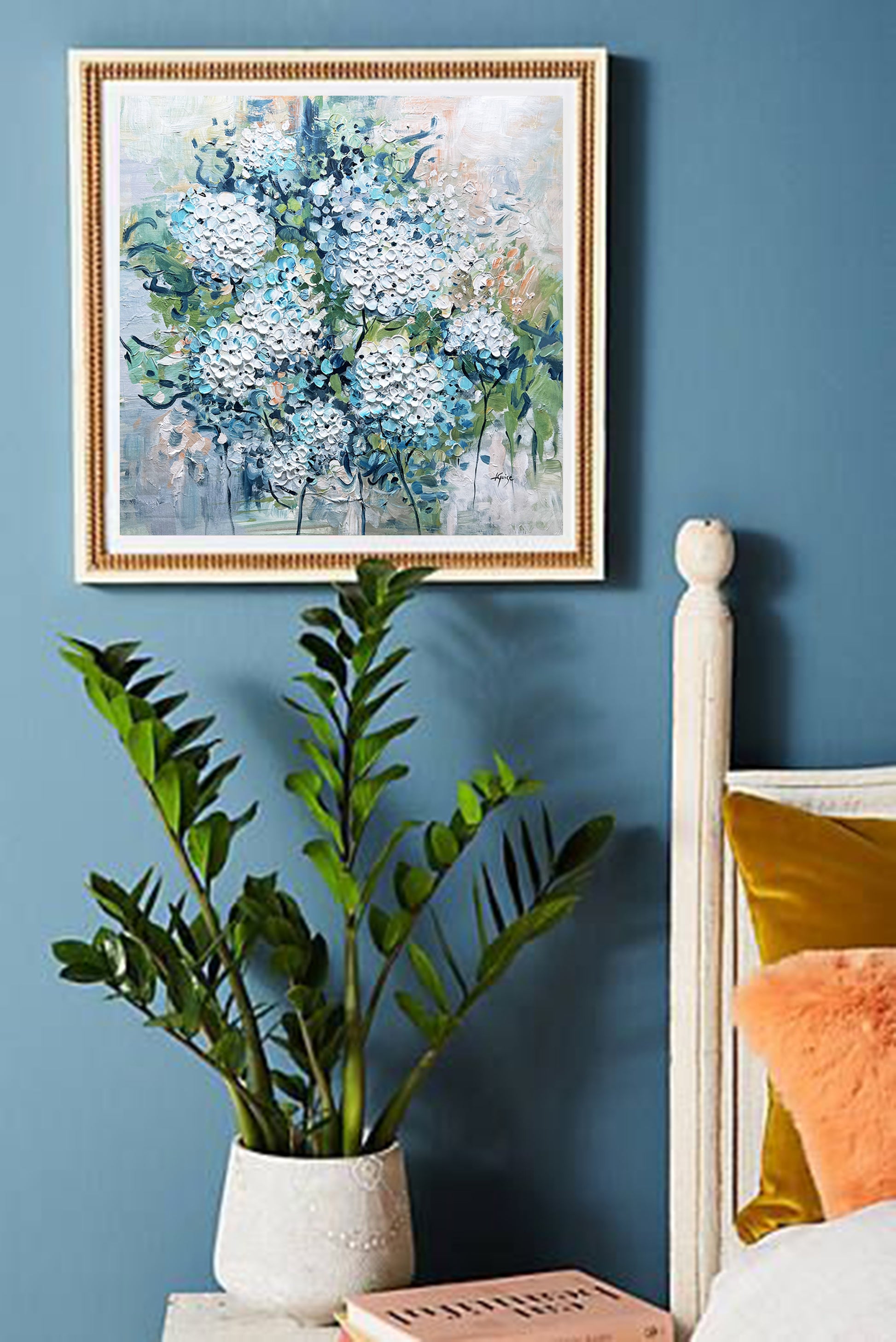 a bedroom with blue walls and a painting on the wall