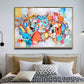 a large abstract painting hangs above a bed